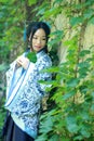 Asian Chinese woman in traditional Blue and white Hanfu dress, play in a famous garden near wall Royalty Free Stock Photo