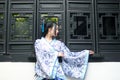 Asian Chinese woman in traditional Blue and white Hanfu dress, play in a famous garden near windows Royalty Free Stock Photo