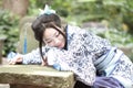 Asian Chinese woman in traditional Blue and white Hanfu dress, play in a famous garden