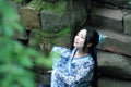 Asian Chinese woman in traditional Blue and white Hanfu dress, play in a famous garden