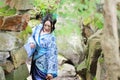 Asian Chinese woman in traditional Blue and white Hanfu dress, play in a famous garden