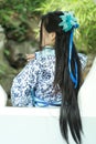 Asian Chinese woman in traditional Blue and white Hanfu dress, play in a famous garden ,Stand in front of the window