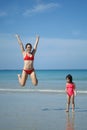 Asian chinese woman spending time playing with daughter at the beach Royalty Free Stock Photo