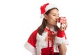 Asian Christmas Santa Claus girl kiss a gift box. Royalty Free Stock Photo