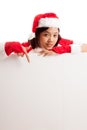 Asian Christmas Santa Claus girl point down to blank sign Royalty Free Stock Photo