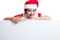 Asian Christmas Santa Claus girl point down to blank sign. Royalty Free Stock Photo