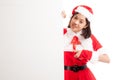 Asian Christmas Santa Claus girl thumbs up with blank sign Royalty Free Stock Photo