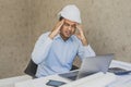 Young asian civil engineer hand in head feeling depressed