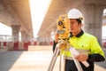 Asian civil engineer or surveyor making measuring under the expressway with theodolite on road works. Survey engineer at road Royalty Free Stock Photo