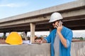 Asian Civil engineer work at road construction sites to supervise new road construction and inspect road construction sites