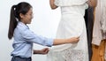 Asian clothing designers are measuring customers` body sizes in preparation for tailoring in design rooms