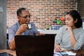 Asian Co-Workers Having Serious Business Discussion in the Kitchen at Home Office Royalty Free Stock Photo