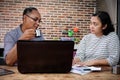 Asian Colleagues Having a Business Meeting in The Kitchen at Home Office Royalty Free Stock Photo