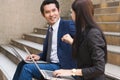 Asian colleagues team success concepts, Businessman and businesswoman looking at each other and doing fist bump celebrate.