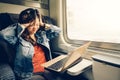 Asian college girl frustrated with laptop on the train, warm light tone, with copy space Royalty Free Stock Photo