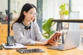 Asian students hang wireless headphones around their necks and write laptops to learn languages online. Watch and listen to laptop