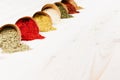 Asian colorful powder spices close up on white wooden board with copy space.