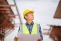 Asian construction engineer checking project at the building site, Architect with a blueprints at a construction site, Foreman Royalty Free Stock Photo