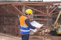 Asian construction engineer checking project at the building site, Architect with a blueprints at a construction site, Foreman Royalty Free Stock Photo