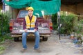 Asian construction site manager wearing safety vest and helmet thinking at architect construction Royalty Free Stock Photo