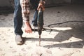 Asian construction worker using mortar extraction machine to drill concrete floor. Royalty Free Stock Photo