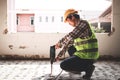 Asian construction worker using mortar extraction machine to drill concrete floor. Royalty Free Stock Photo