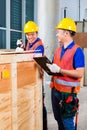 Asian construction workers on site open wood box