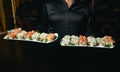 Asian cook hold a sushi roll dish Royalty Free Stock Photo