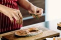 Asian Cook Is sprinkling herb on raw salmon To prepare food on the modern kitchen counter Royalty Free Stock Photo