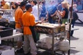 Asian cooks serving food at concessions.