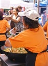 Asian cooks serving food at concessions Royalty Free Stock Photo