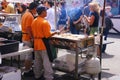 Asian cooks serving food at concessions Royalty Free Stock Photo