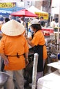 Asian cooks serving food at concessions Royalty Free Stock Photo