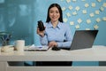 Asian corporate employee holding black bottle of pills Royalty Free Stock Photo