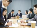 Asian corporate people discussing business in meeting