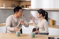 Asian couple arguing while drinking coffee at kitchen Royalty Free Stock Photo