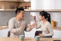 Asian couple arguing while drinking coffee at kitchen Royalty Free Stock Photo