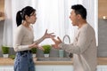 Asian couple arguing at kitchen, wife yelling at husband Royalty Free Stock Photo