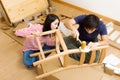 Asian couple assembling new chair