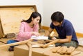 Asian couple assembling new furniture