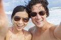 Asian Couple at Beach Taking Selfie Photograph Royalty Free Stock Photo