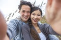 Asian Couple at Beach Taking Selfie Photograph Royalty Free Stock Photo