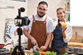 Asian couple blogger vlogger and online influencer recording video content on healthy food in the kitchen Royalty Free Stock Photo