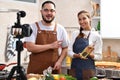 Asian couple blogger vlogger and online influencer recording video content on healthy food in the kitchen Royalty Free Stock Photo