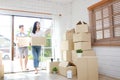 Asian couple buy a new house, hold a paper box to put things in. Royalty Free Stock Photo