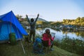 Couple Enjoying Camping Holiday In Countryside.Camp in the mountains near of the lake Royalty Free Stock Photo