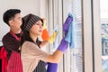 Asian couple cleaning window. Housework together Royalty Free Stock Photo