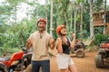asian couple clenching their arms in front of the atv track arena