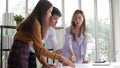 Asian couple discussing house purchases and information with project salespeople.