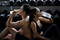 Asian couple drink water after dumbbell exercise Royalty Free Stock Photo